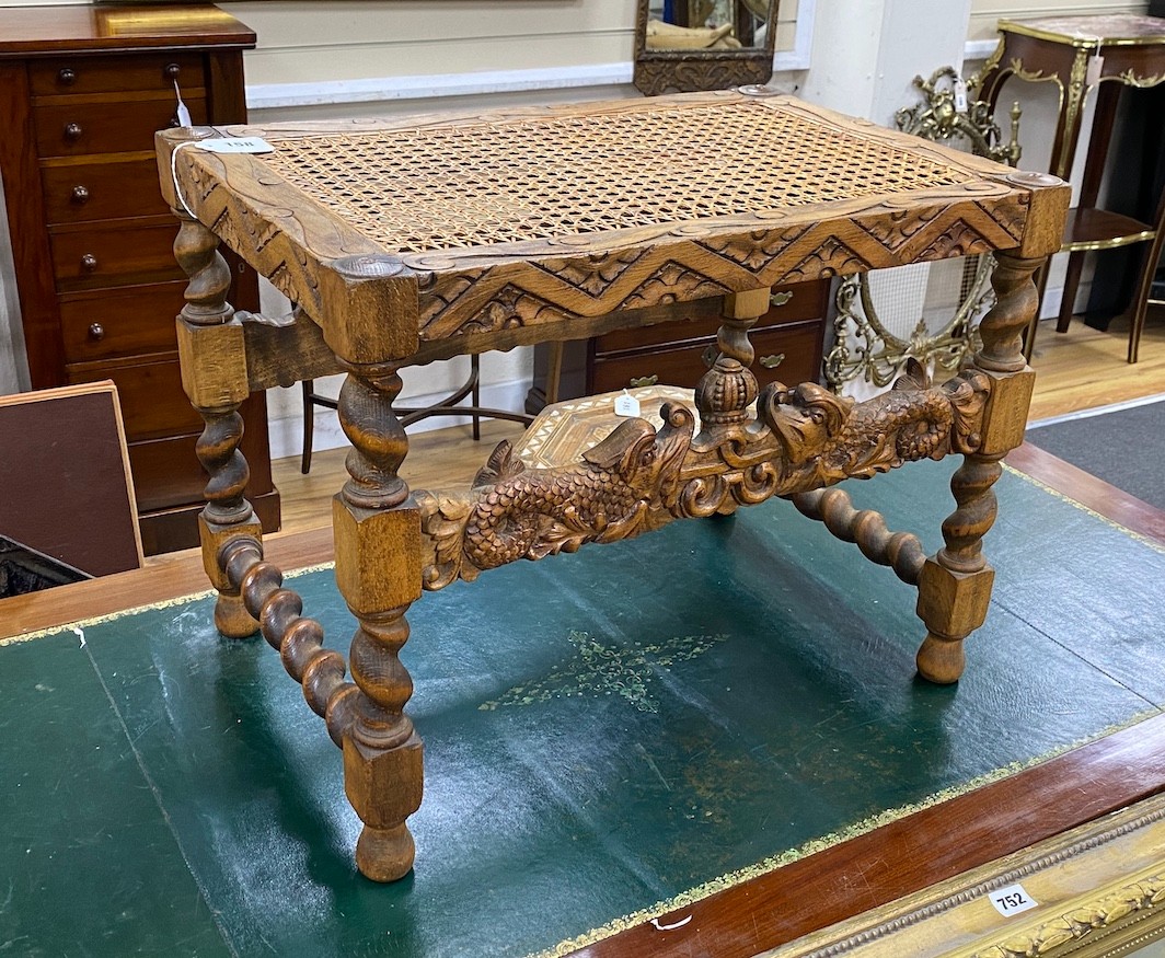 A Jacobean revival caned carved beech stool width 59cm, height 46cm.